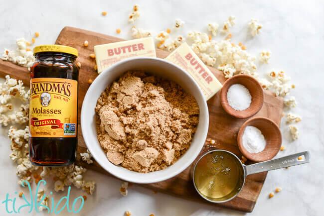 Homemade caramel corn ingredients on a wooden cutting board.