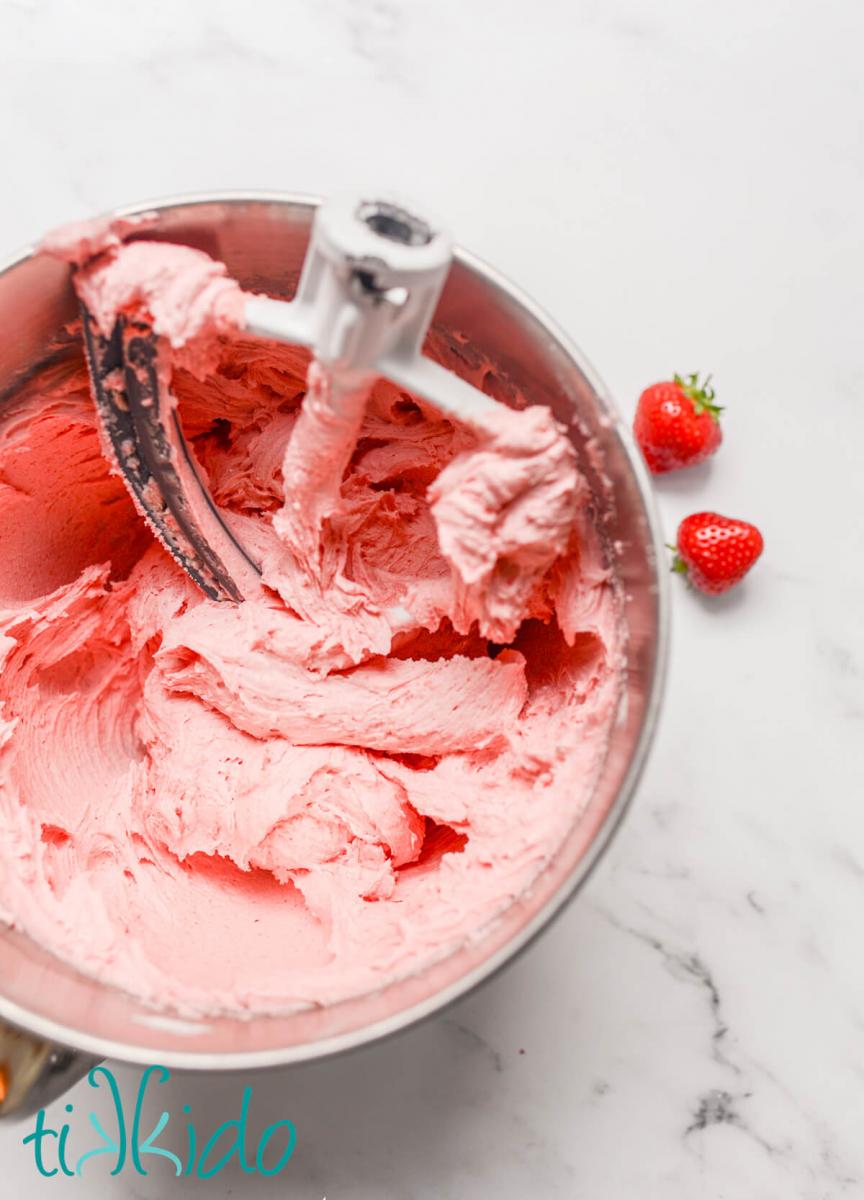 Pink Strawberry Frosting in a kitchenaid mixing bowl.