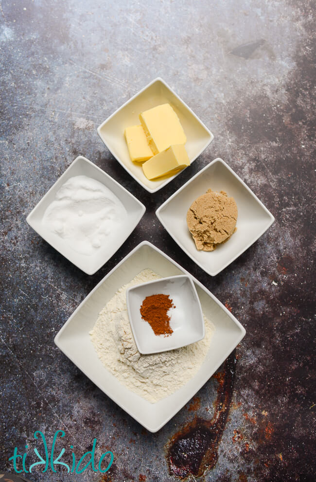 Ingredients for crumb topping for muffins in white bowls on a grey background.