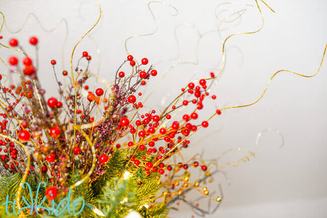 Closeup of DIY tree topper made with floral picks and curly ting ting.
