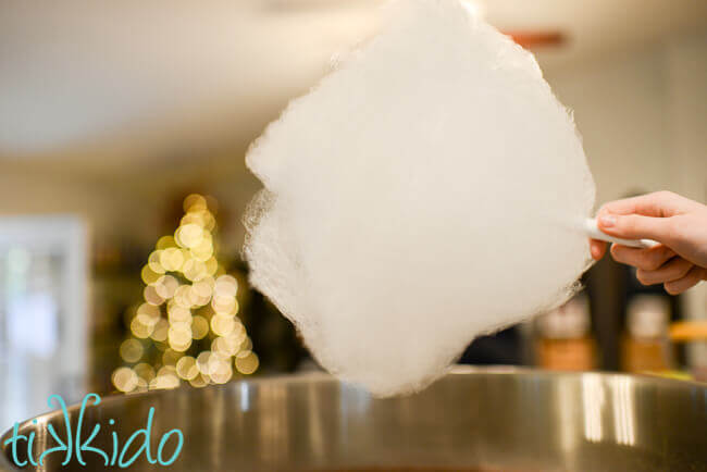 cotton candy being made in a cotton candy machine.