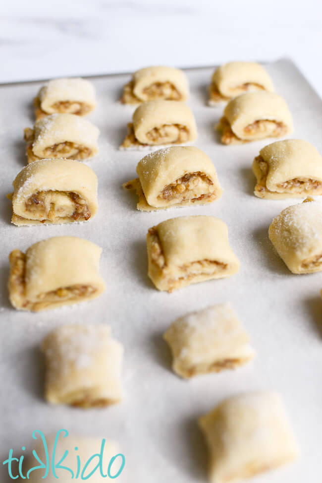Easy rugelach cookies ready to make on a parchment lined cookie sheet.