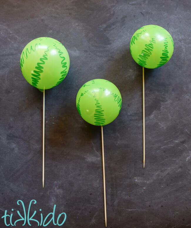 Watermelon balloon cake toppers on bamboo skewers.