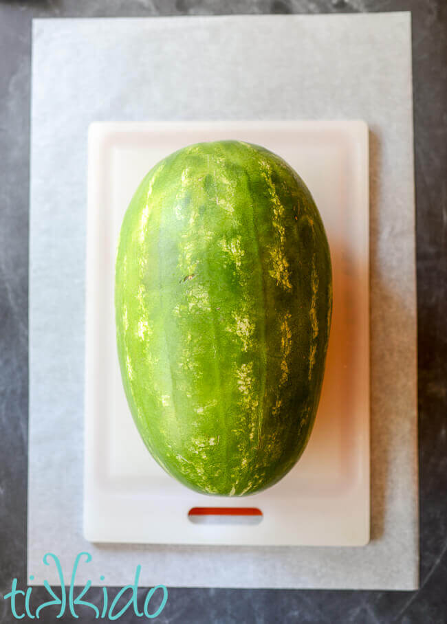 Large watermelon on a cutting board.