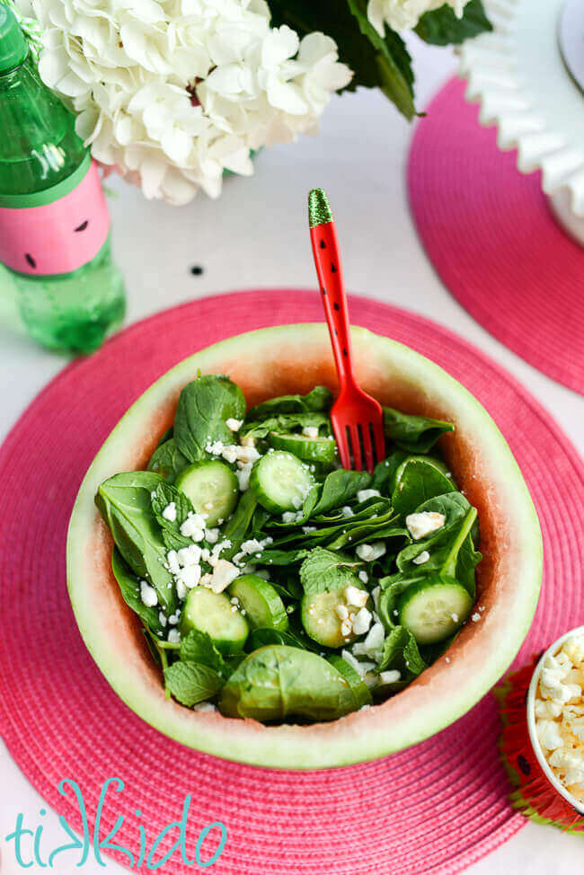 Watermelon feta salad served in a bowl made from a hollowed out mini watermelon.