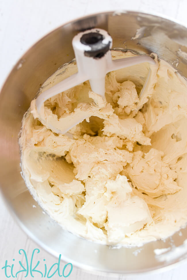 whipped mascarpone filling in a mixing bowl with a kitchenaid beater.