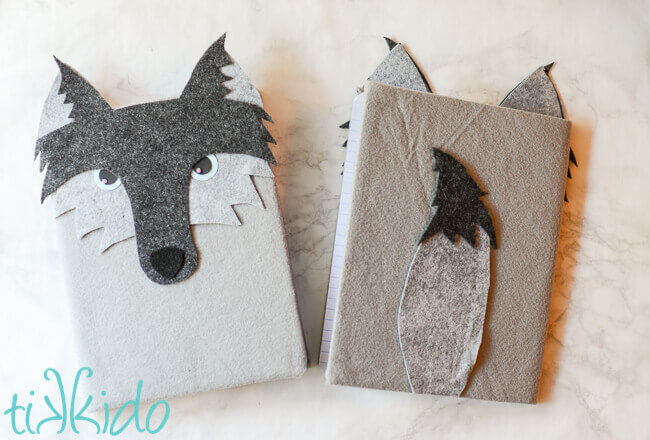 Front and back view of a felt wolf notebook made from a composition book.