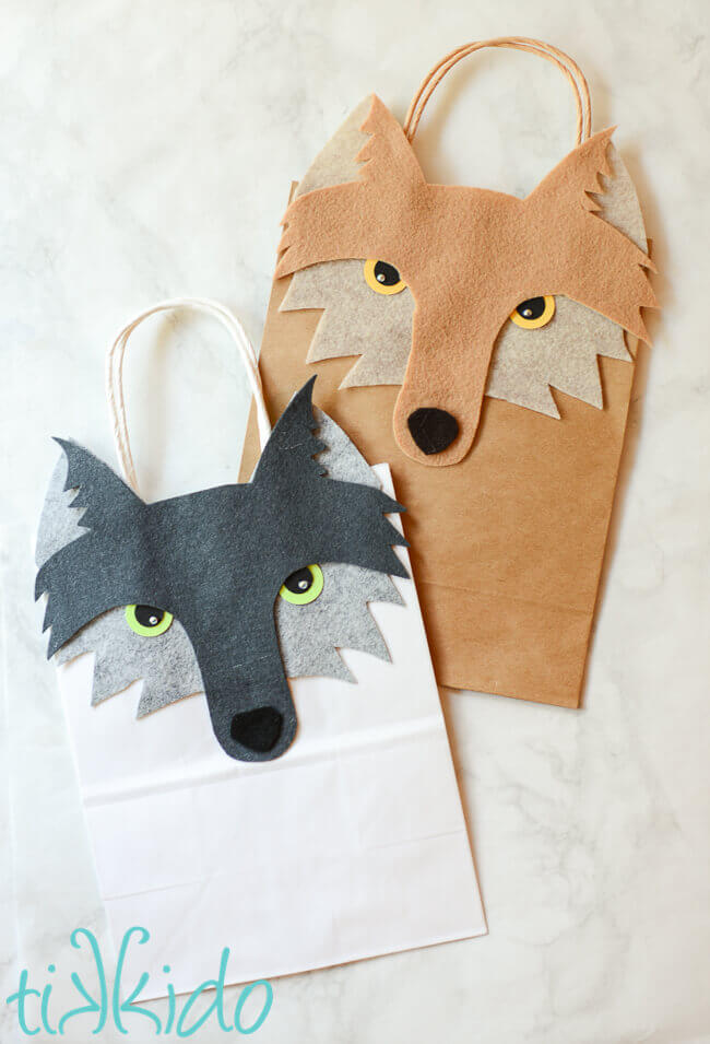 Two gift bags decorated with felt wolf faces