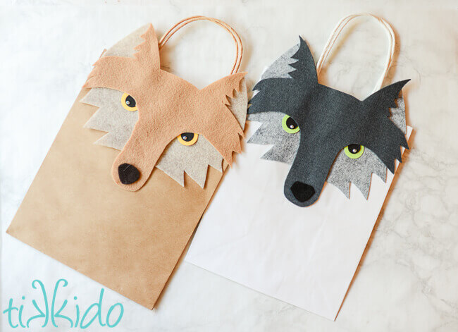 Two gift bags decorated with felt wolf faces