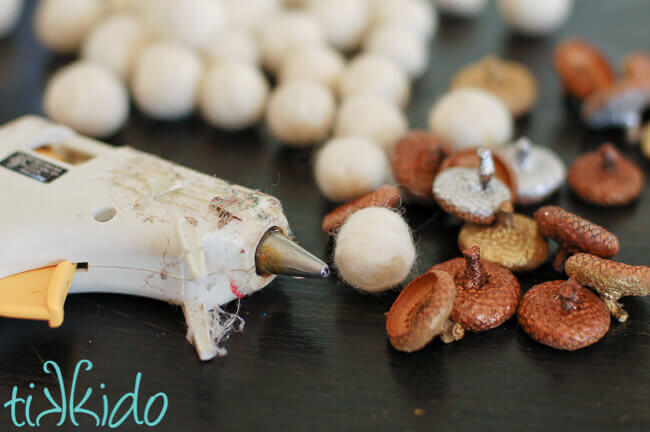 Felt Acorns being made out of real acorn caps and felt balls glued together.