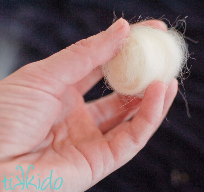 wool roving wound into a loose ball to be turned into a wool felt ball.