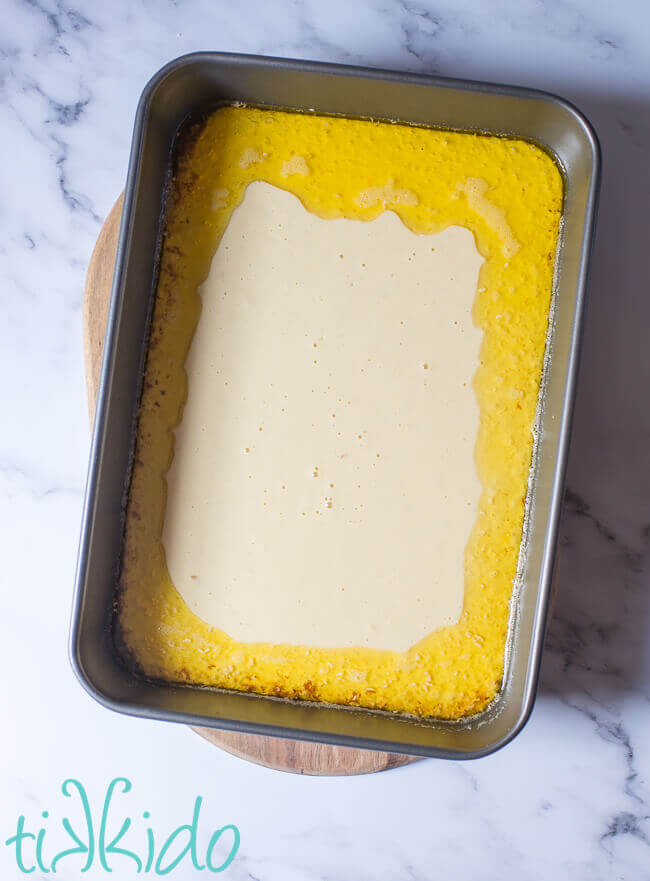 Yorkshire pudding batter poured into a hot pan full of browned butter.