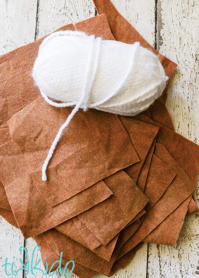 Brown felt and white yarn for covering the felt gingerbread house.