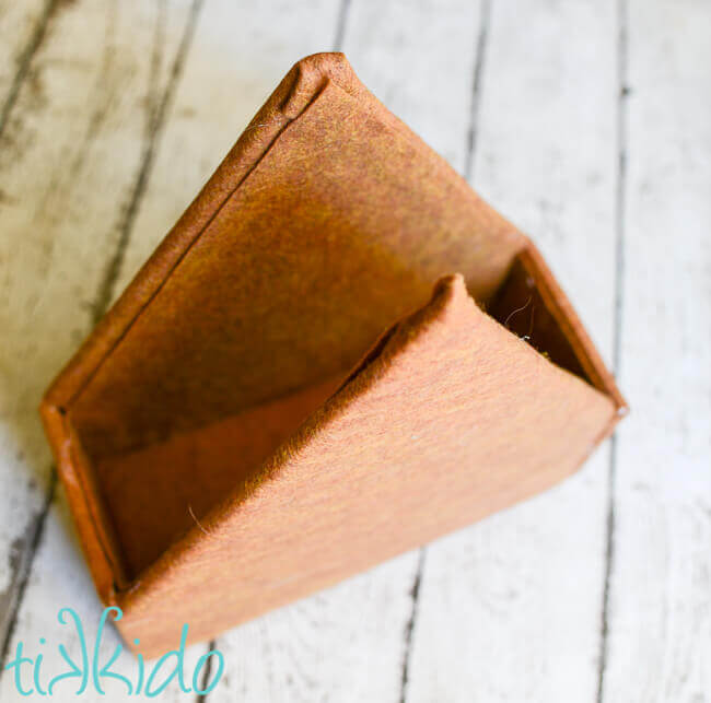 Foam core structure of a gingerbread house covered with brown felt to make a Felt Gingerbread House toy.