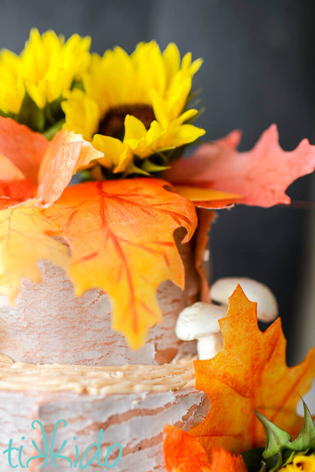 Cake decorated with edible fall leaves made out of wafer paper.