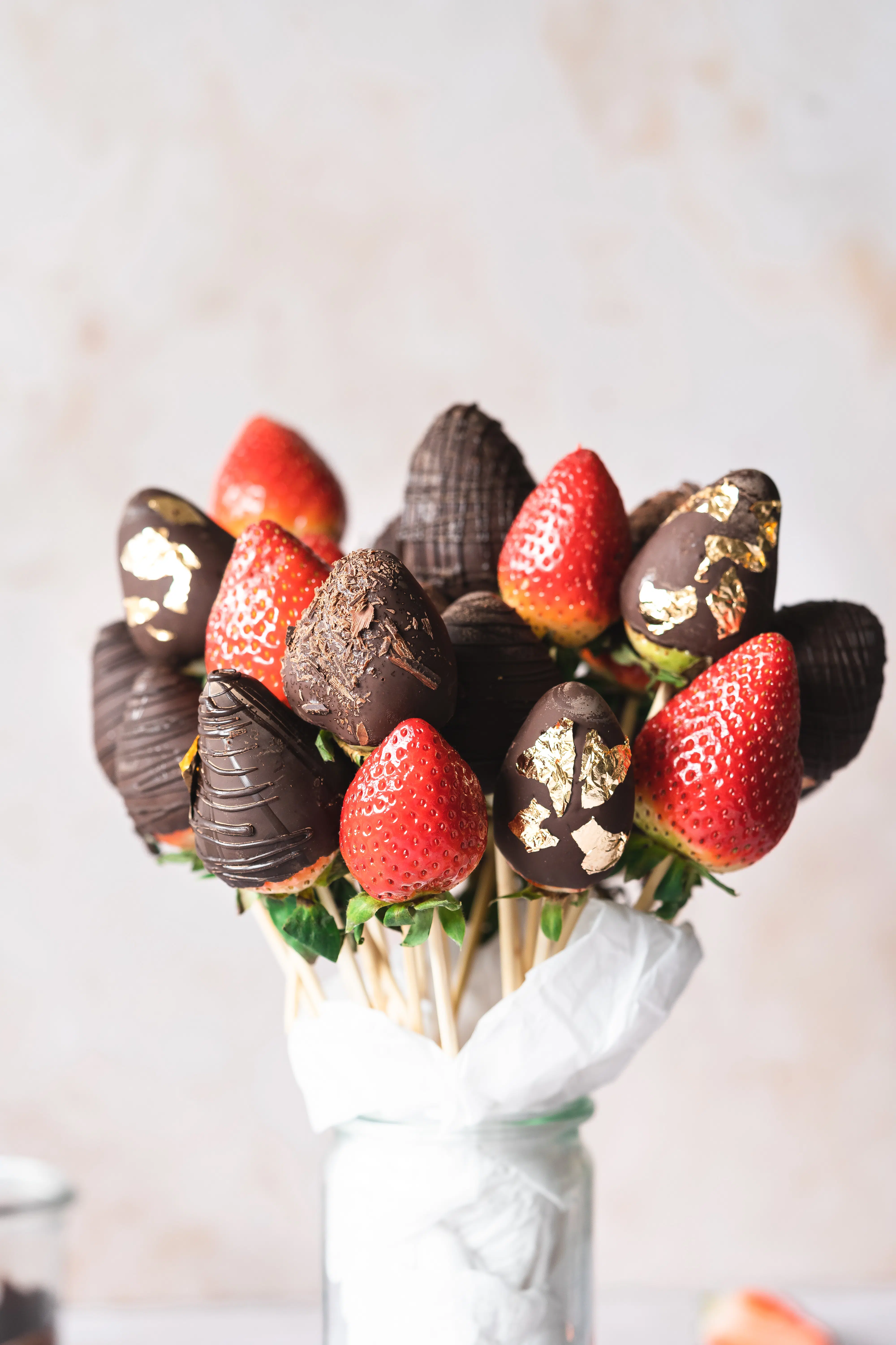 Chocolate covered strawberry bouquet in a glass vase.