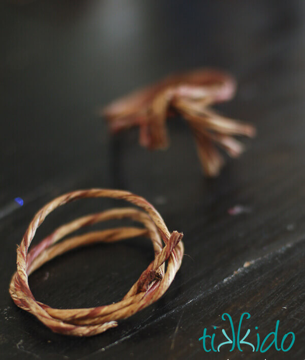 Grapevine floral wire bent into the basic DIY napkin ring for making Felt Acorn Napkin Rings.