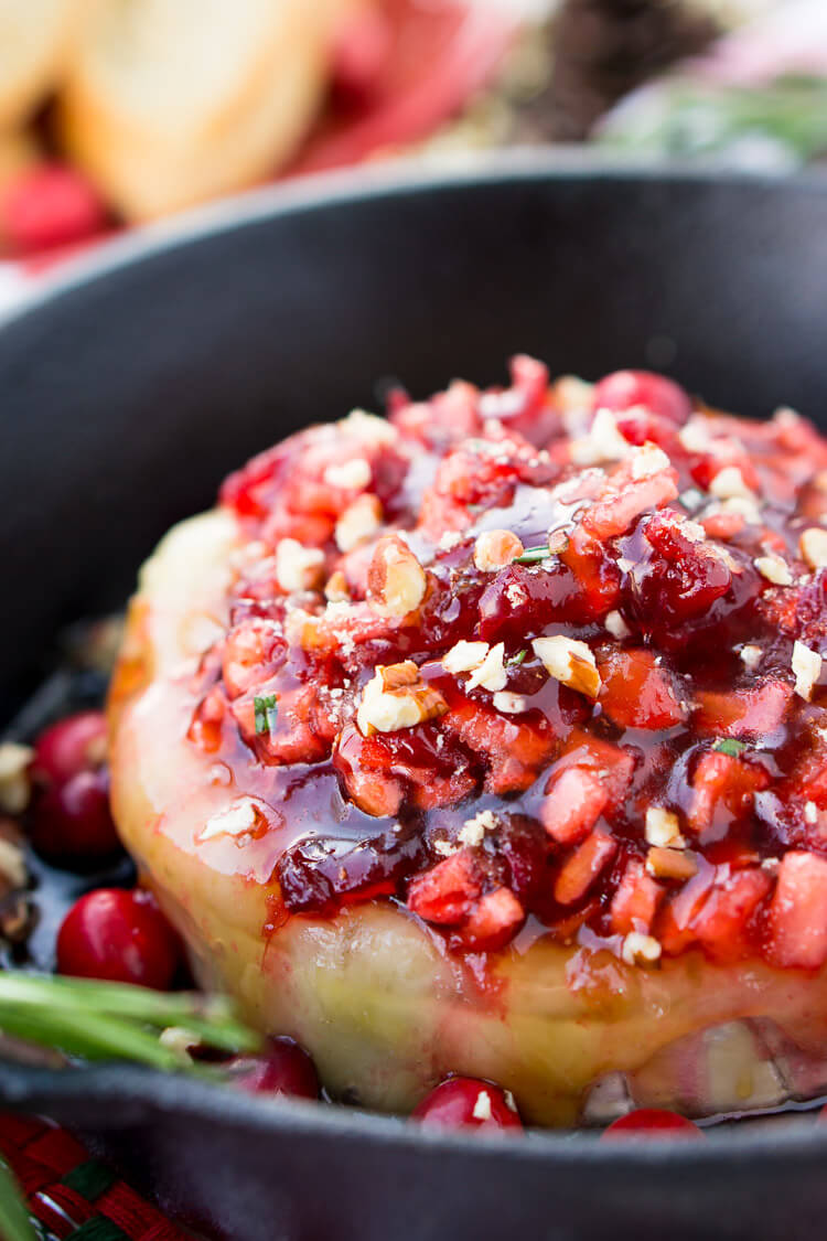 Cranberry and Apple Baked Brie apple appetizer in a cast iron skillet.