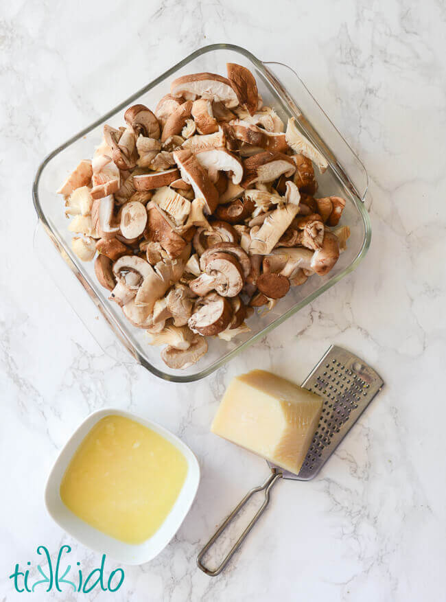 Sliced mushrooms in a pyrex baking dish to make oven roasted mushrooms.