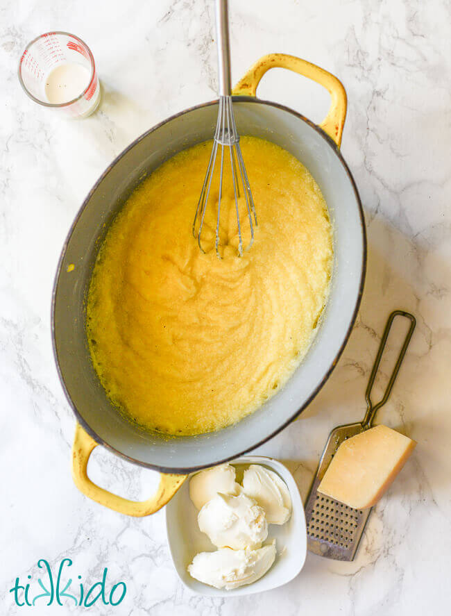 Oven baked polenta being whisked after baking.