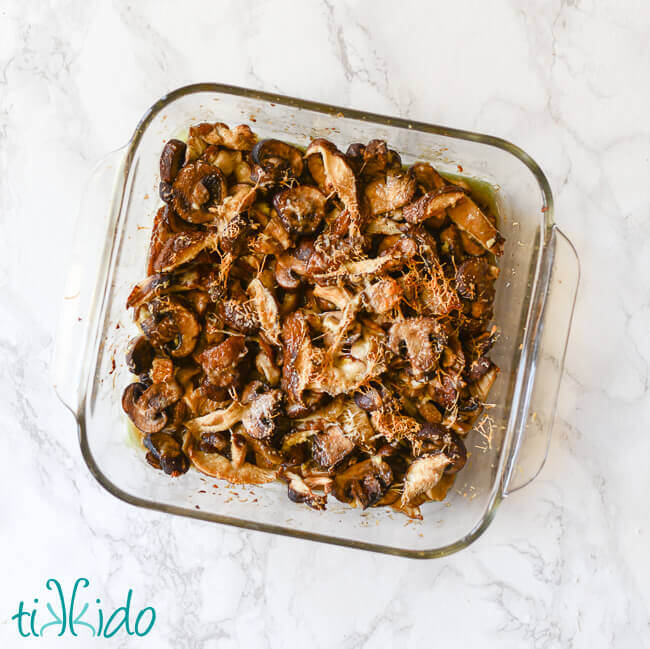 Oven roasted mushrooms in a pyrex baking dish.