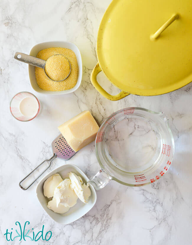 Ingredients for Recipe for Baked Polenta on a white marble surface.