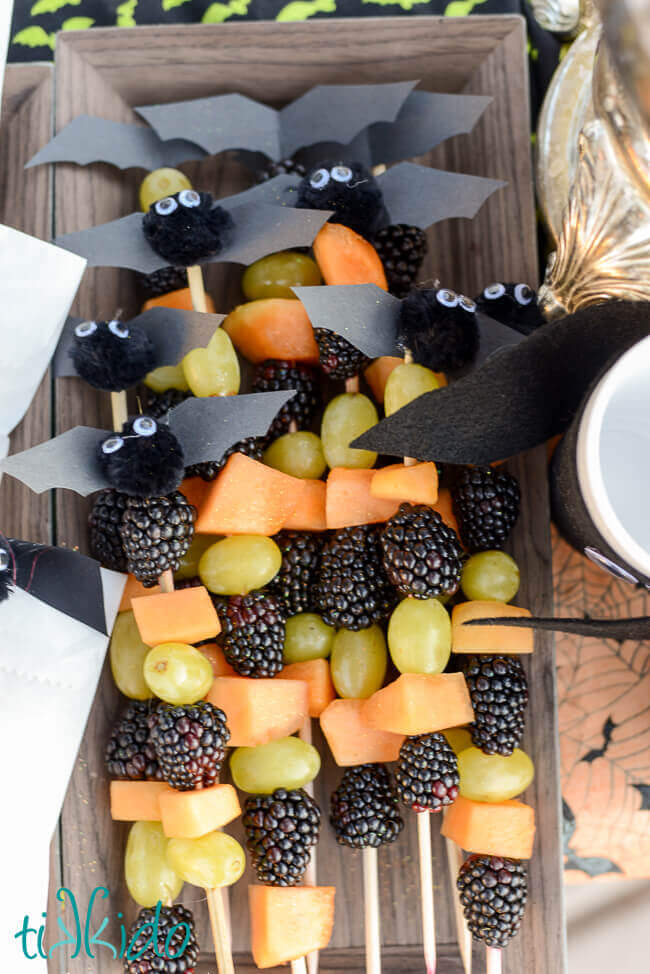 Healthy Halloween fruit skewers topped with  cute little bats.