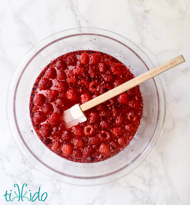 Raspberries cooked with sugar and water to make raspberry simple syrup