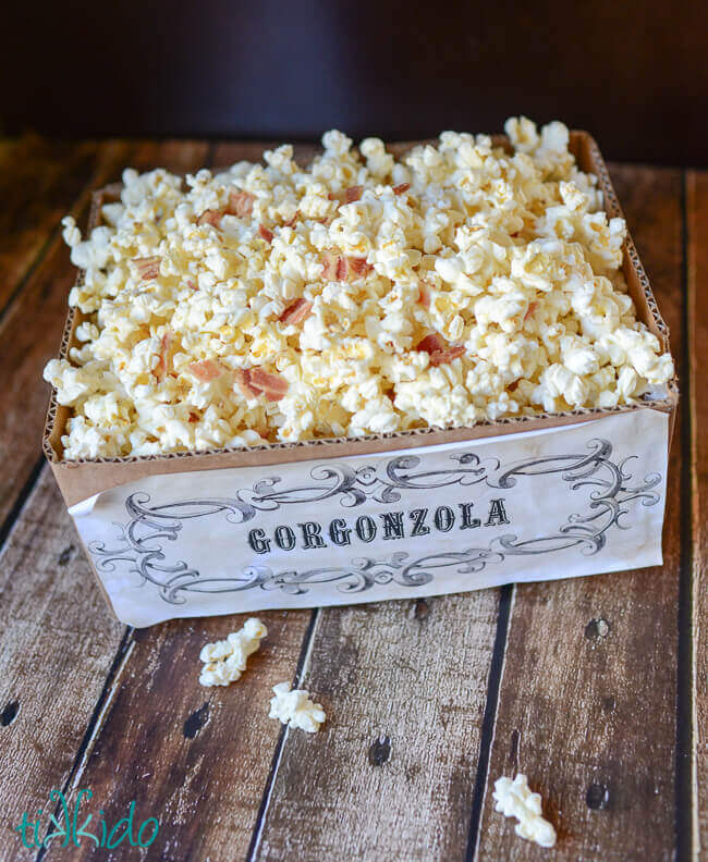Gorgonzola and bacon popcorn in a brown cardboard box labeled "gorgonzola."