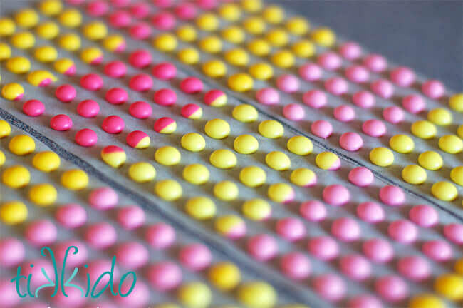 Closeup of homemade pink and yellow candy buttons made with a Candy Buttons Recipe