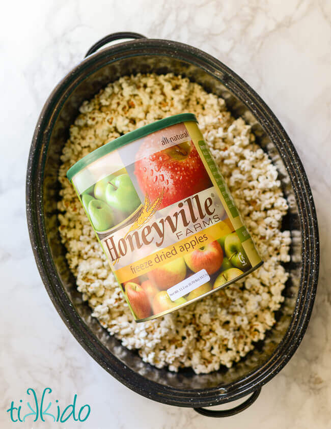 Roasting pan full of popcorn and a canister of freeze dried apples