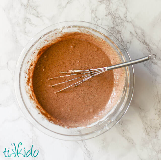 Chocolate waffle batter for chocolate waffles recipe in a clear pyrex bowl