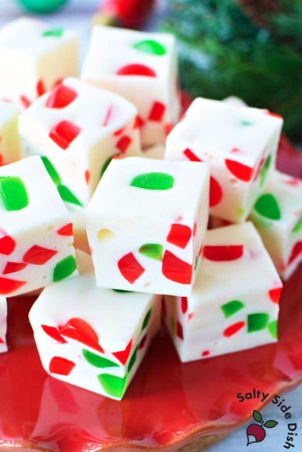 Christmas Nougat Candy, white candy with pieces of red and green gumdrops mixed in, stacked on a red plate.