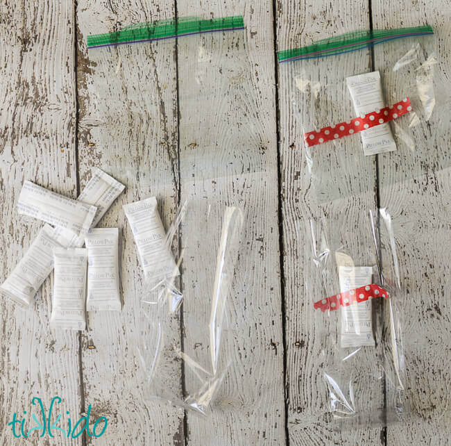 Four clear plastic bags, desiccant packets taped inside two of them.