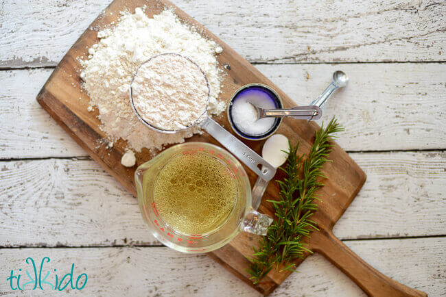 Ingredients for homemade crackers on a wooden cutting board.