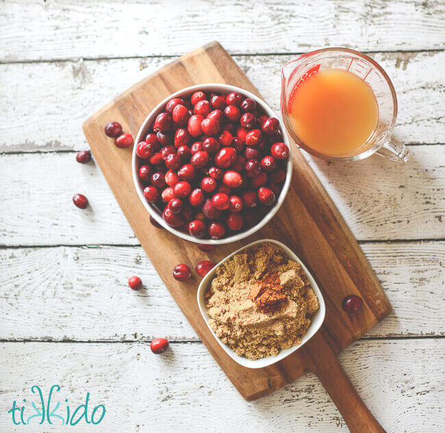 Cranberry butter ingredients on a wooden cutting board.