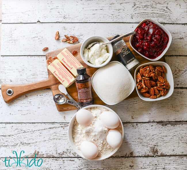 Cranberry Nut Bread ingredients on a white weathered wood background.