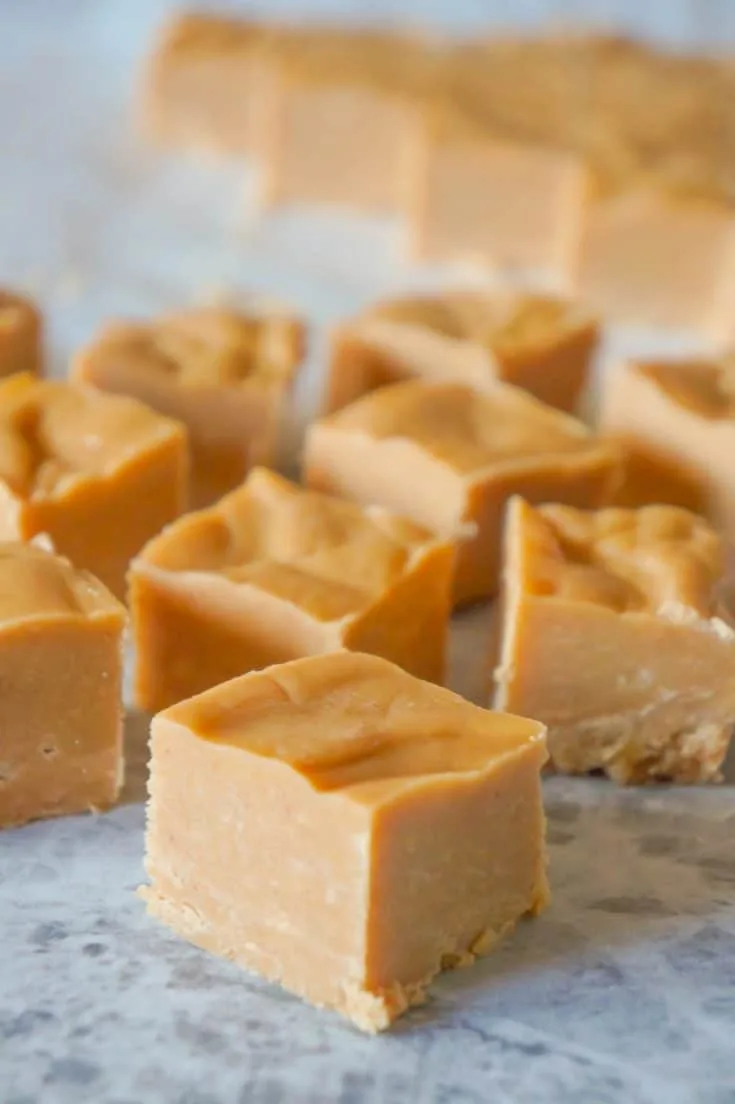 Easy peanut butter fudge on a grey work surface.