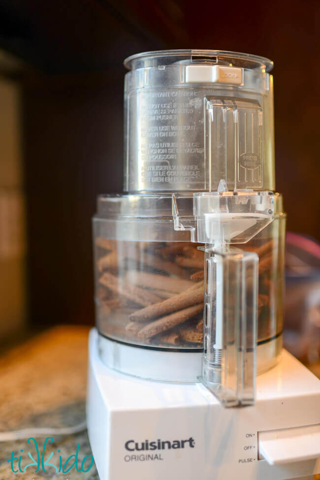 Pieces of gingerbread being turned into crumbs in a Cuisinart food processor to make gingerbread crumb pie crust.