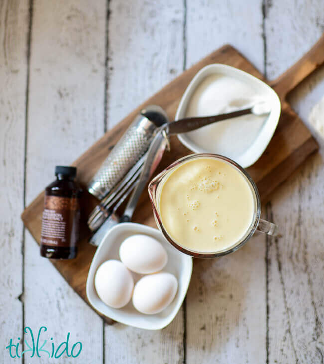 Ingredients for eggnog pie recipe on a wooden cutting board.