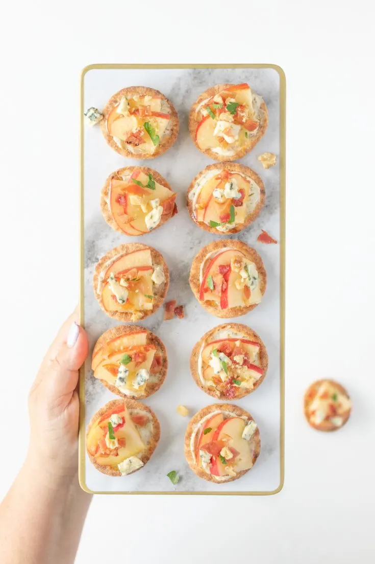 Easy raw apple appetizers on a marble serving tray.