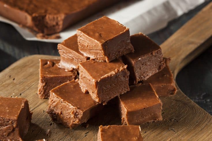 Instant pot chocolate fudge pieces on a wooden cutting board.