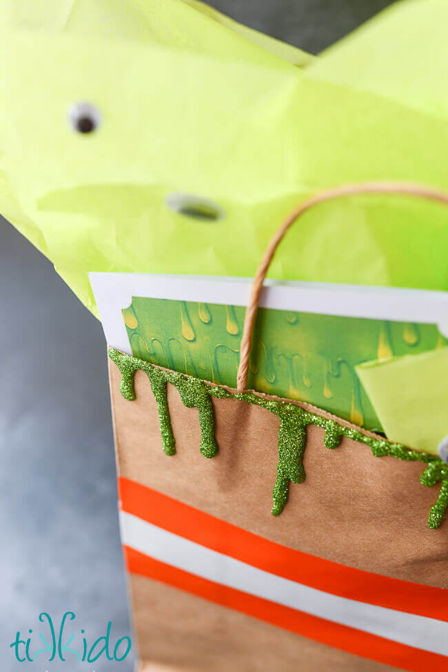 Glitter slime decorations on a Ghostbusters themed gift bag.