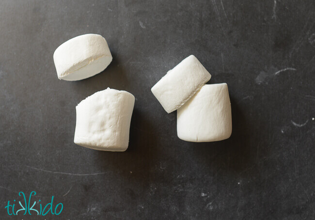 Marshmallows cut into pieces, showing how to cut the marshmallows and assemble them to make Stay Puft Marshmallow Treats.