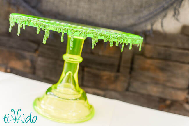 Glitter slime garland decorating a green vaseline glass cake plate.
