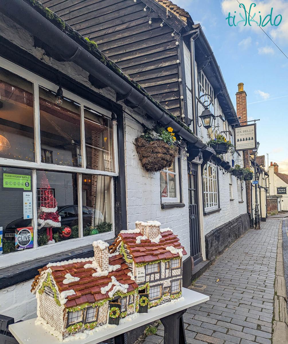 Gingerbread replica of The Six Bells pub in St Albans, England, in front of the pub.