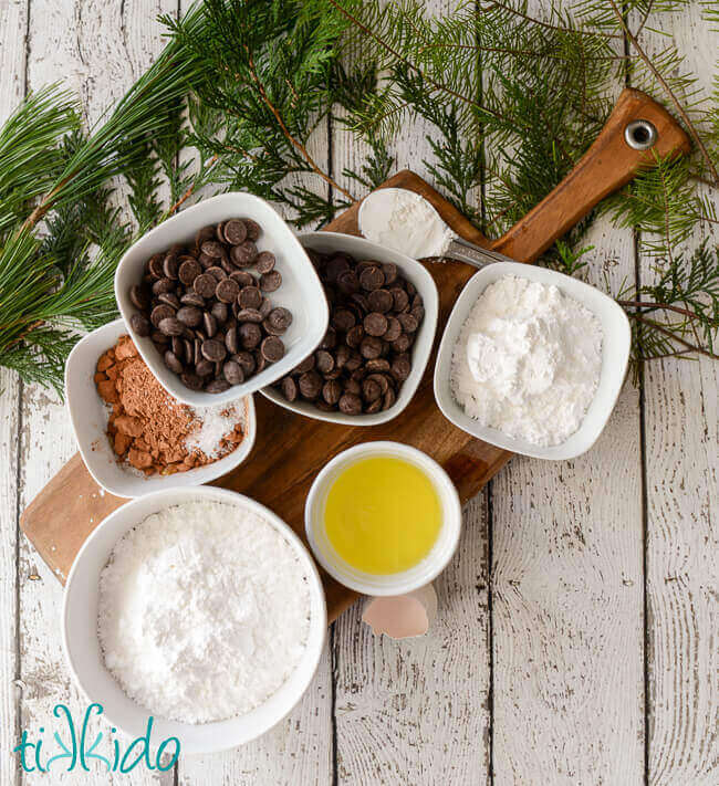 Gluten Free chocolate crinkle cookie ingredients on a wooden cutting board