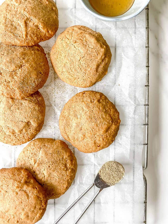 Honey spice spelt cookies, an eggless cookie recipe, on parchment paper on a wire cooling rack.