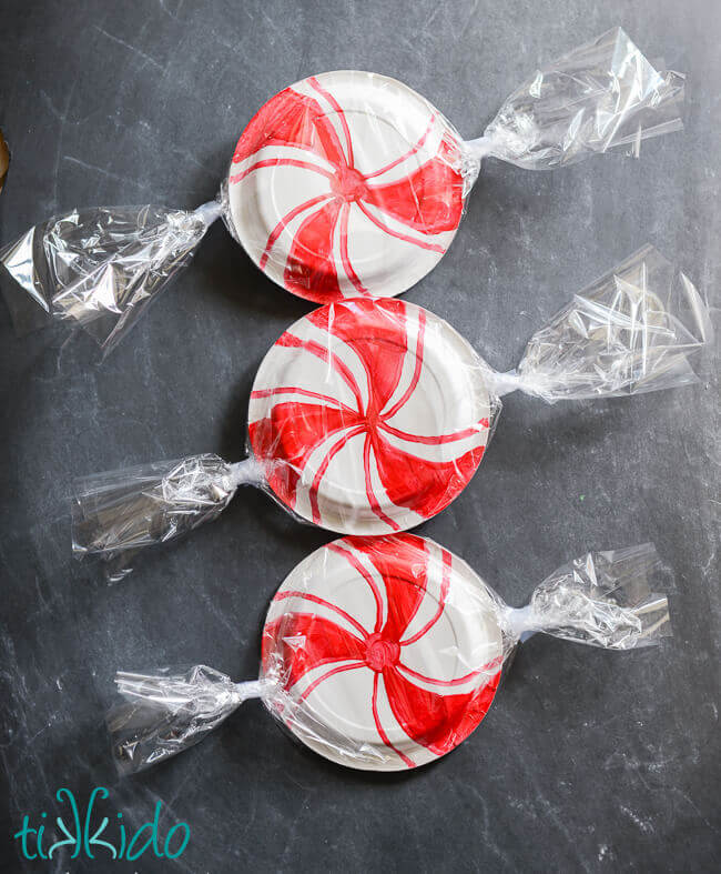 Paper plates decorated to look like giant peppermint candies.