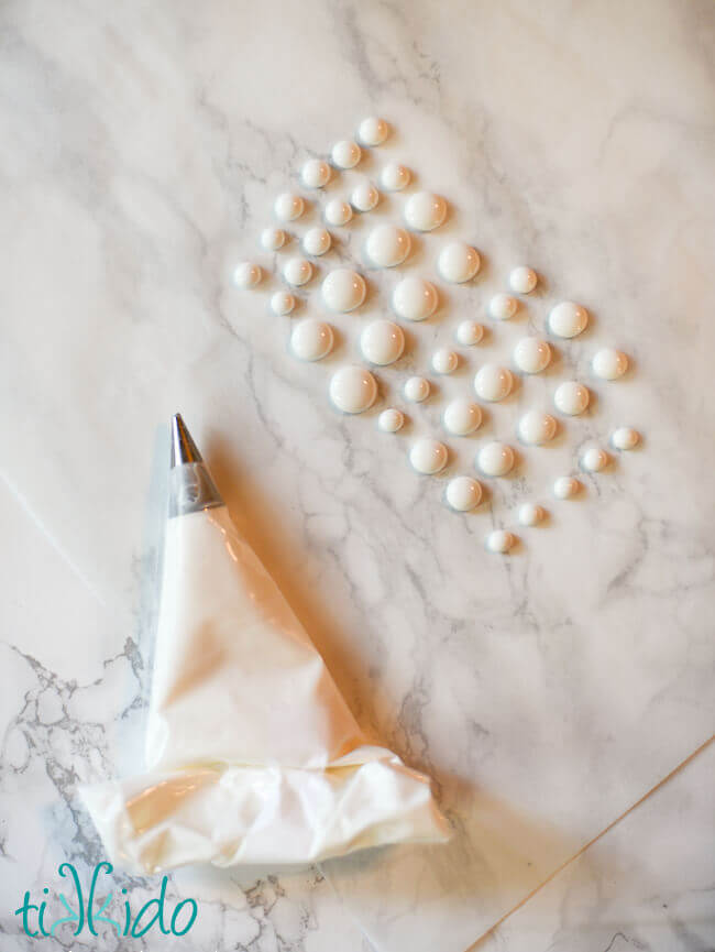 Edible Googly Eyes being made out of royal icing.